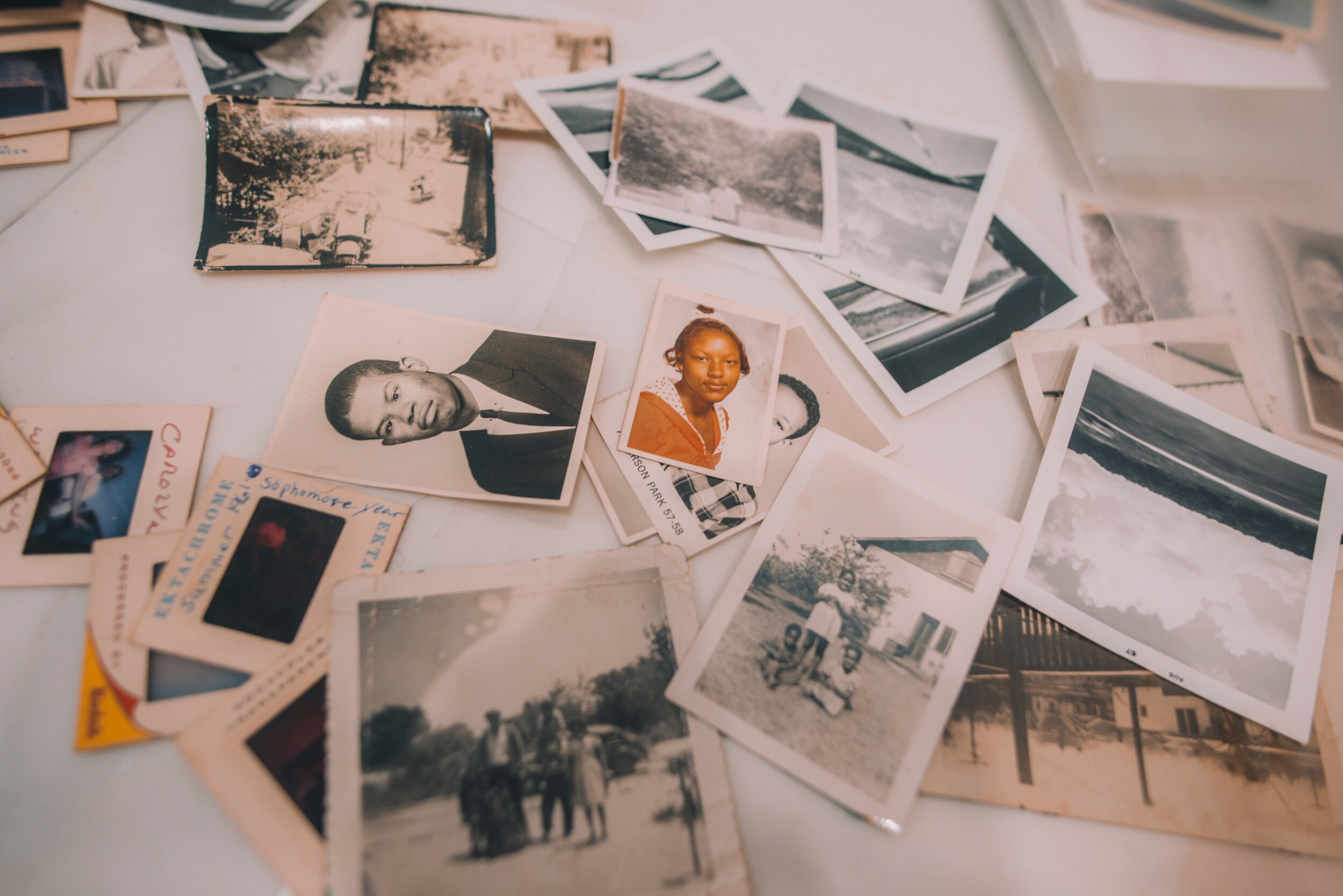 older photographs spread around a table 