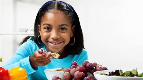 Child eating healthy foods.