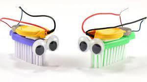 two bristlebots (robots made from toothbrush heads and batteries) facing each other
