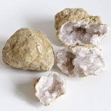 photo of one unbroken geode and one that has been broken showing white quartz inside