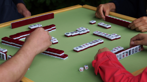 mah jong table with  green felt four players playing game 