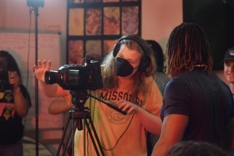 youth works with professional video camera