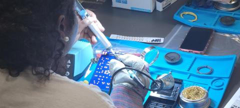 Image of teen using soldering tools for a small project.