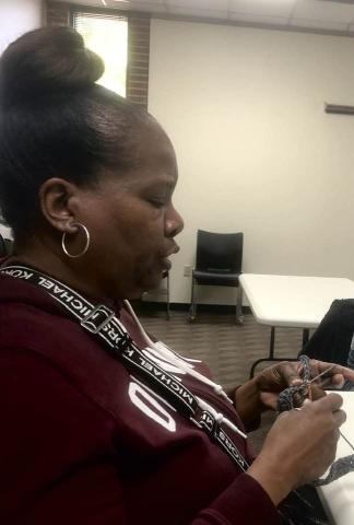 Adult practices her skills at the Cherokee Library Crochet Club.