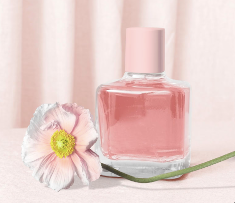 A fragrance bottle and flower
