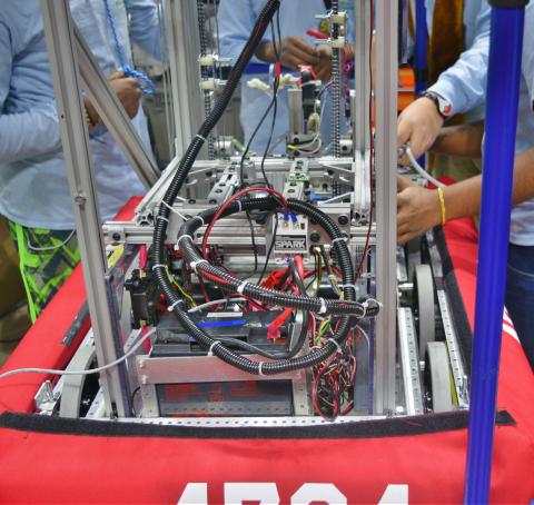 Robotics Team members fixing their robot