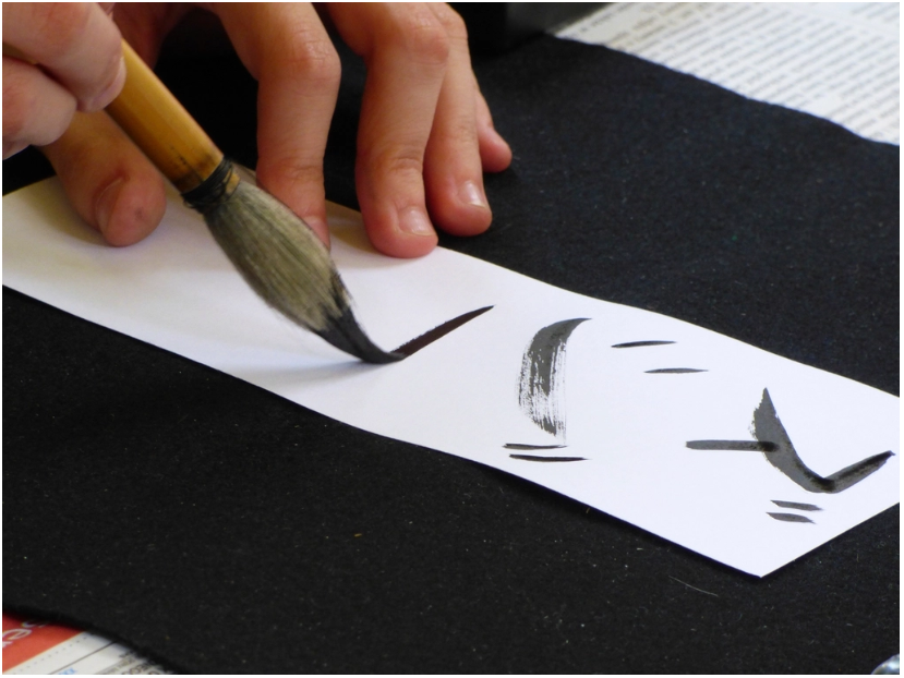 person doing calligraphy