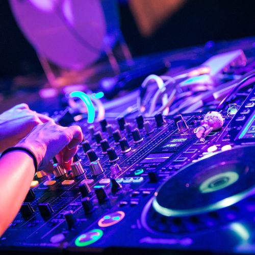 DJ mixing music with colorful lights