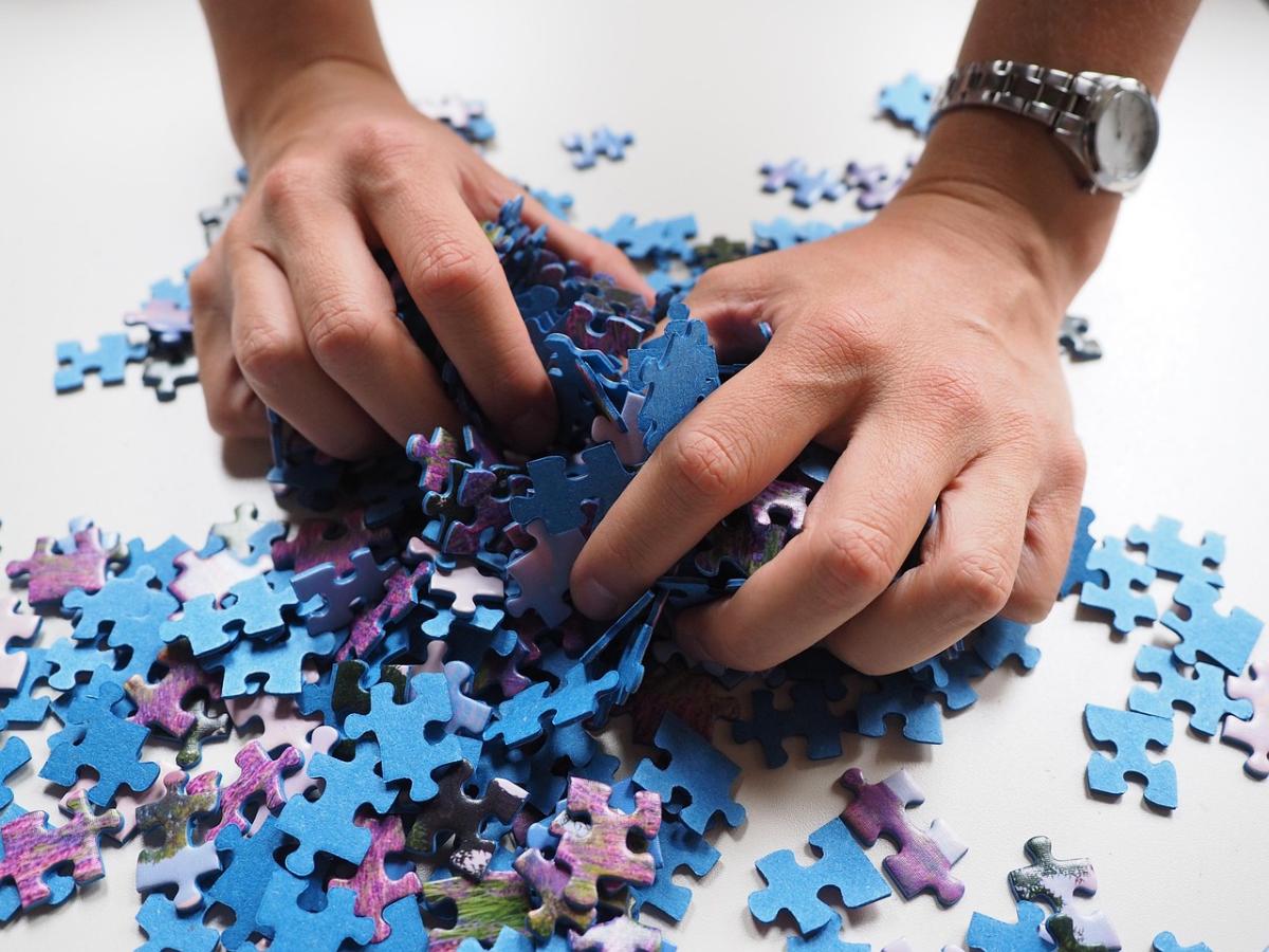 hands on a jigsaw puzzle