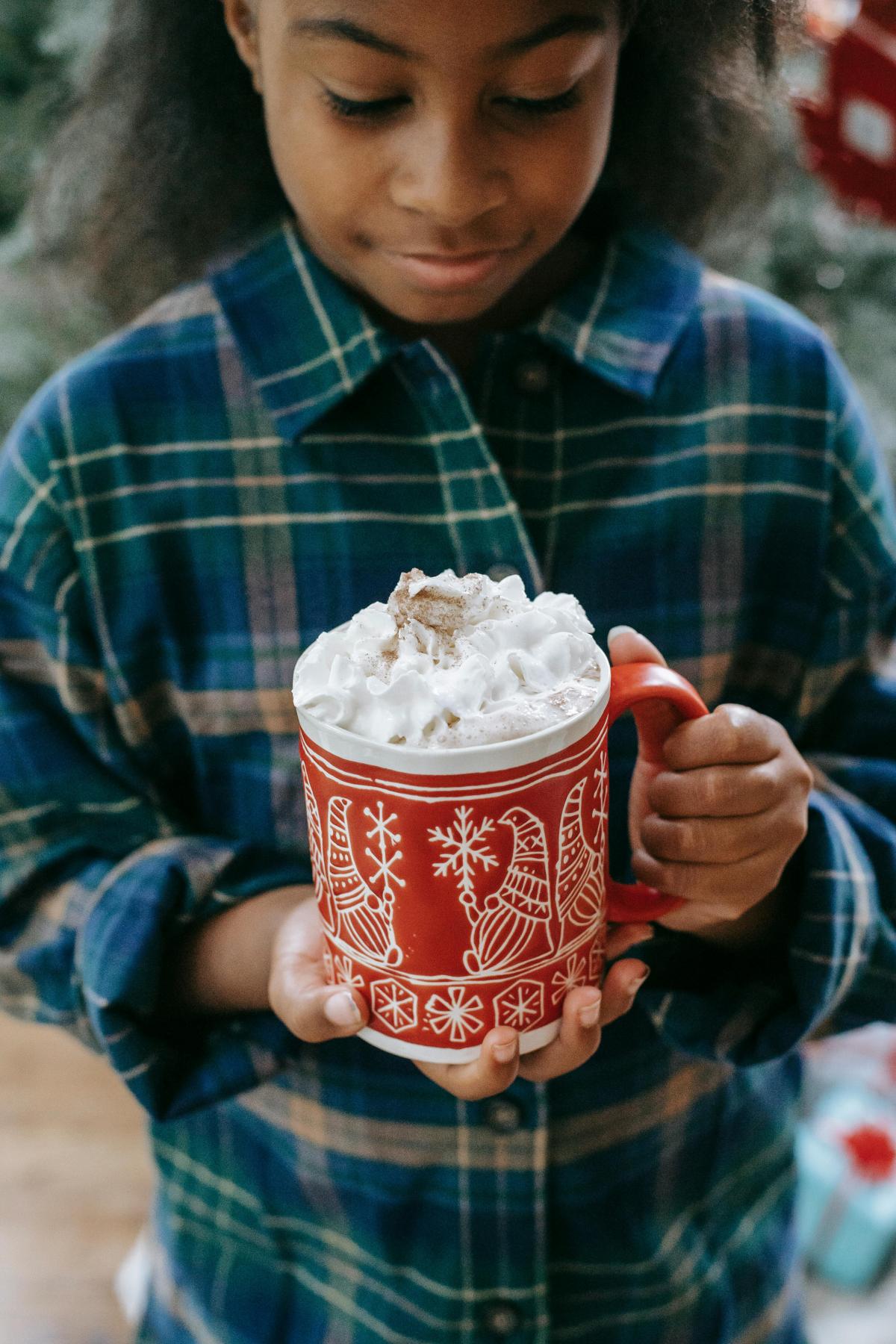 young girl with a cup of cocoa