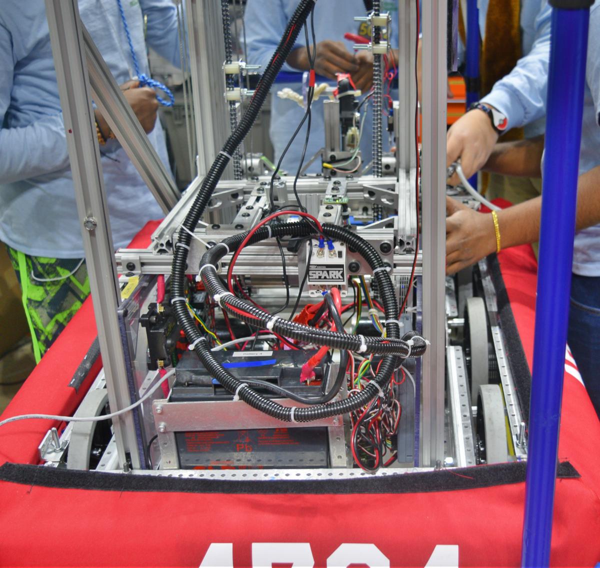 Robotics Team members fixing their robot